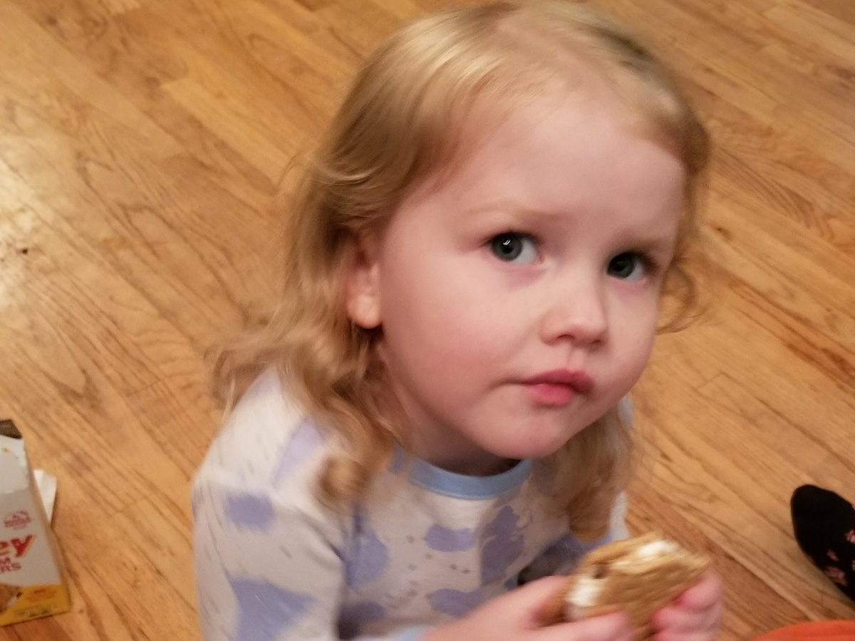 Elowyn eating a smore